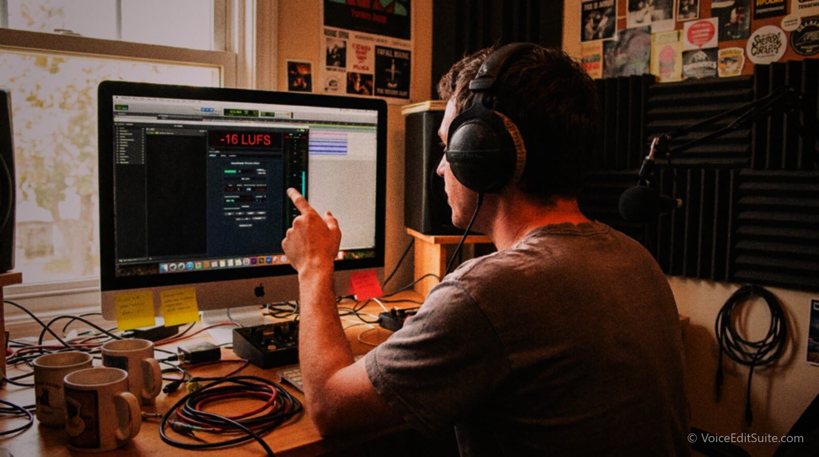 A podcaster checking a loudness meter on screen as an episode plays