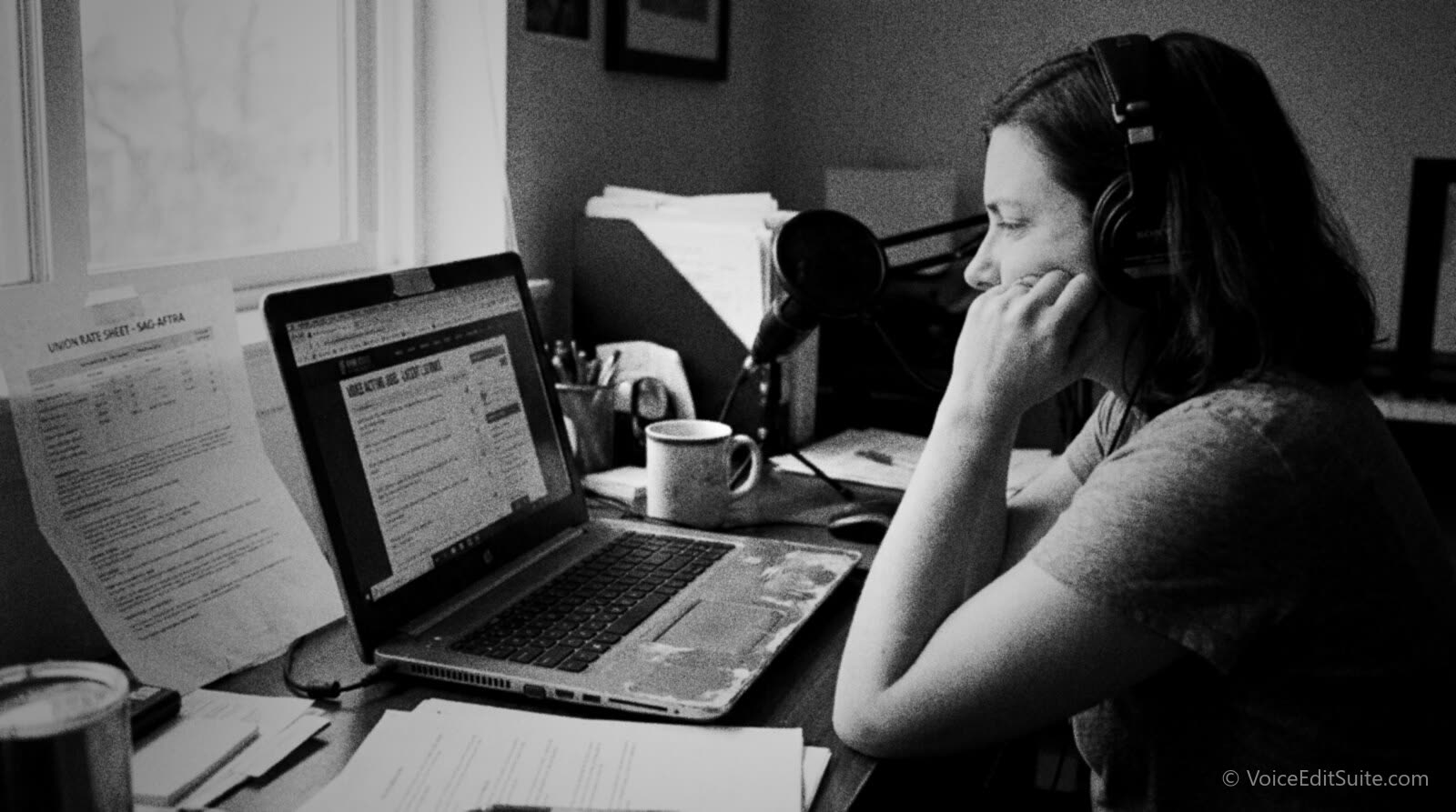 Black and white photograph of a voice actor scrolling through a long list of non-union job postings